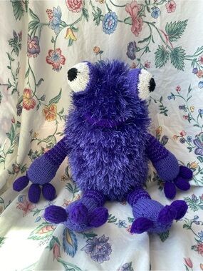 Purple crocheted amigurumi fuzzy monster plush toy